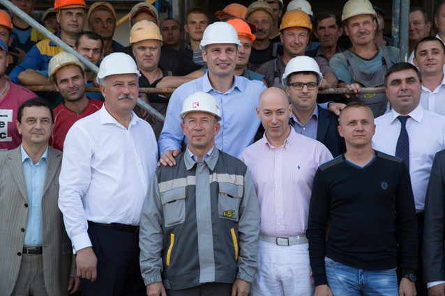 Виталий Кличко, Вячеслав Непоп (второй в первом ряду слева), Дмитрий Гордон и руководитель Подольской райгосадминистрации Валентин Мондриевский (второй во втором ряду справа) среди строителей «Жовтня»